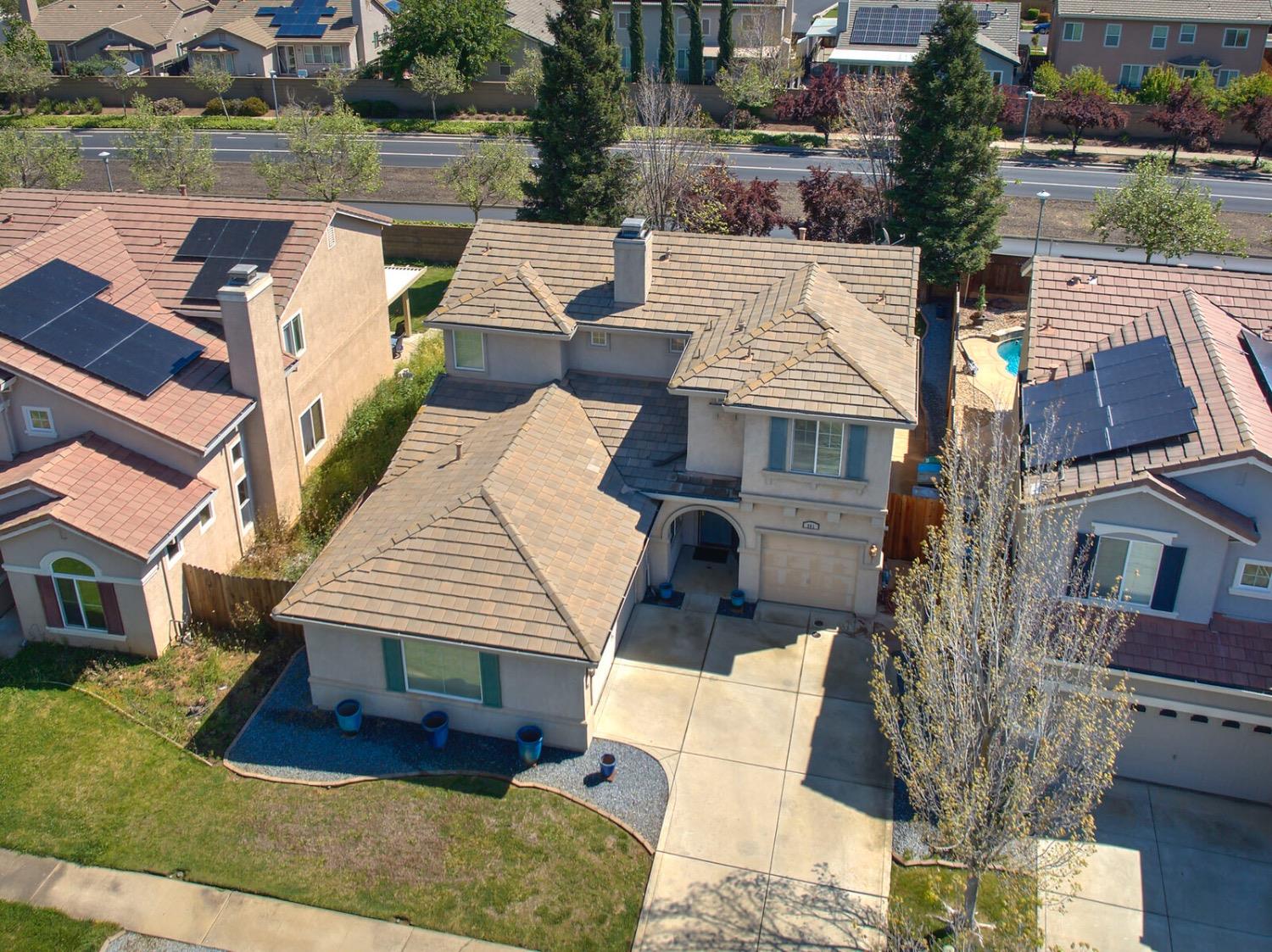 an aerial view of a house with a yard and balcony