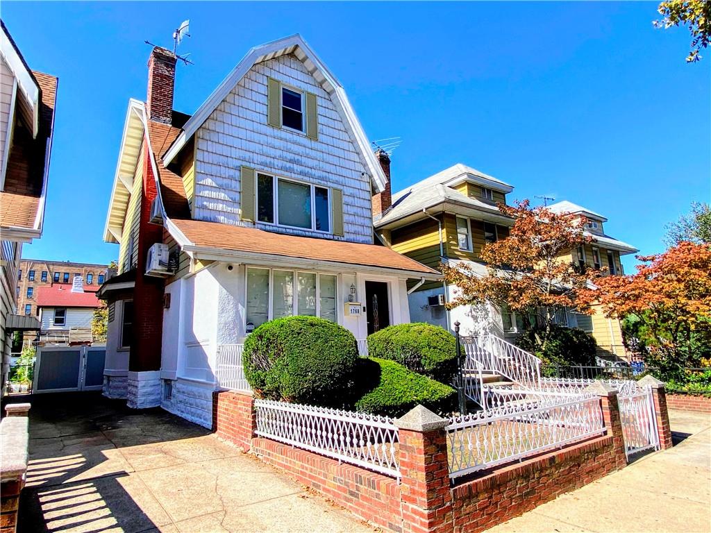 a view of a house with wooden fence