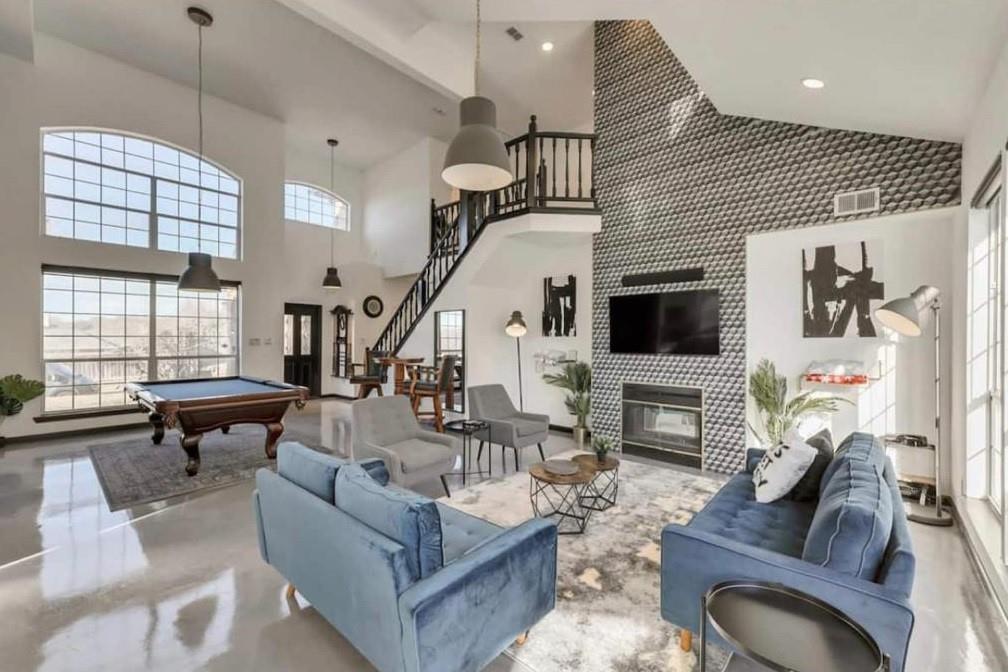 a living room with furniture fireplace and a flat screen tv