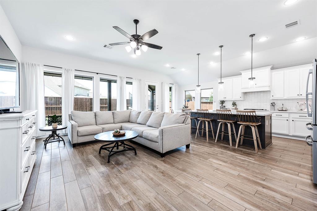 a living room with furniture and kitchen view