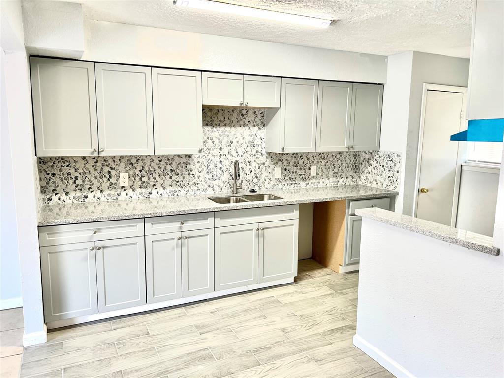 a kitchen with a sink and cabinets