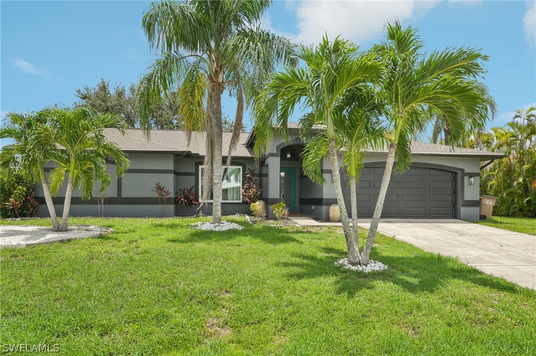 a front view of house with yard and green space