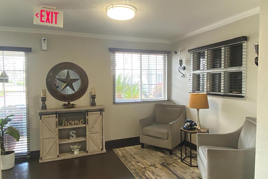 a living room with furniture a window and a potted plant