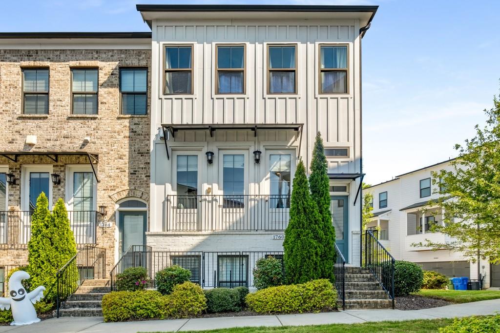 a front view of a residential apartment building with a yard