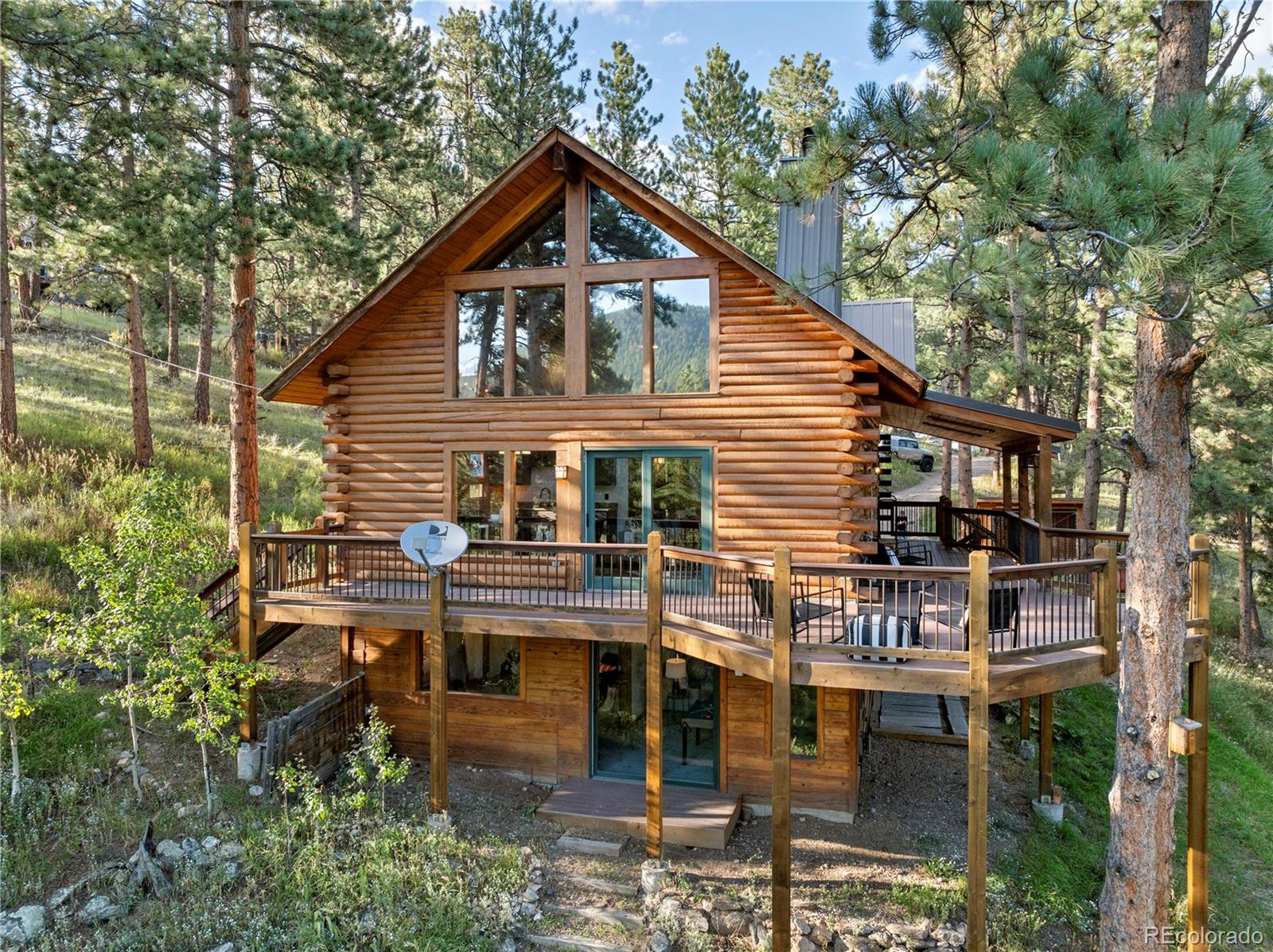 a view of house with outdoor seating and trees