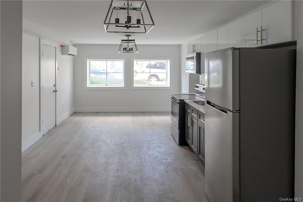 a kitchen with stainless steel appliances a refrigerator and a stove top oven