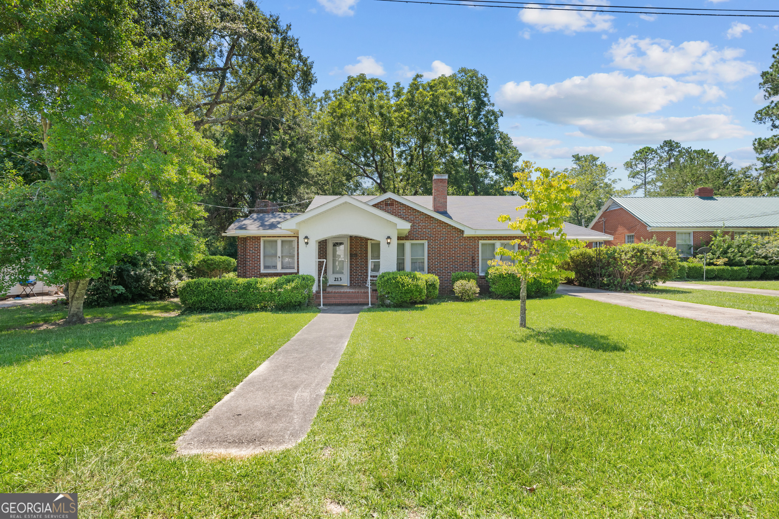 a front view of a house with garden