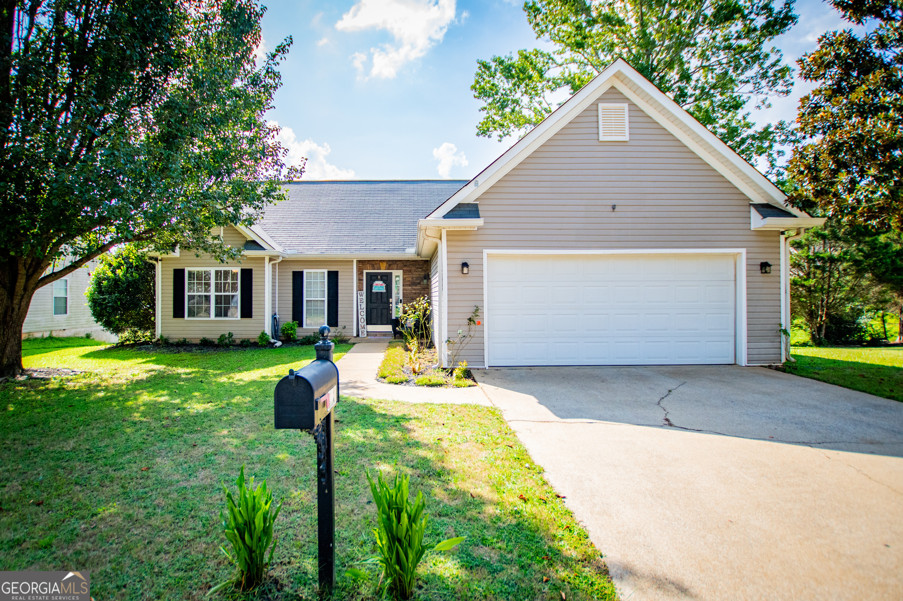 a front view of house with yard outdoor seating and green space