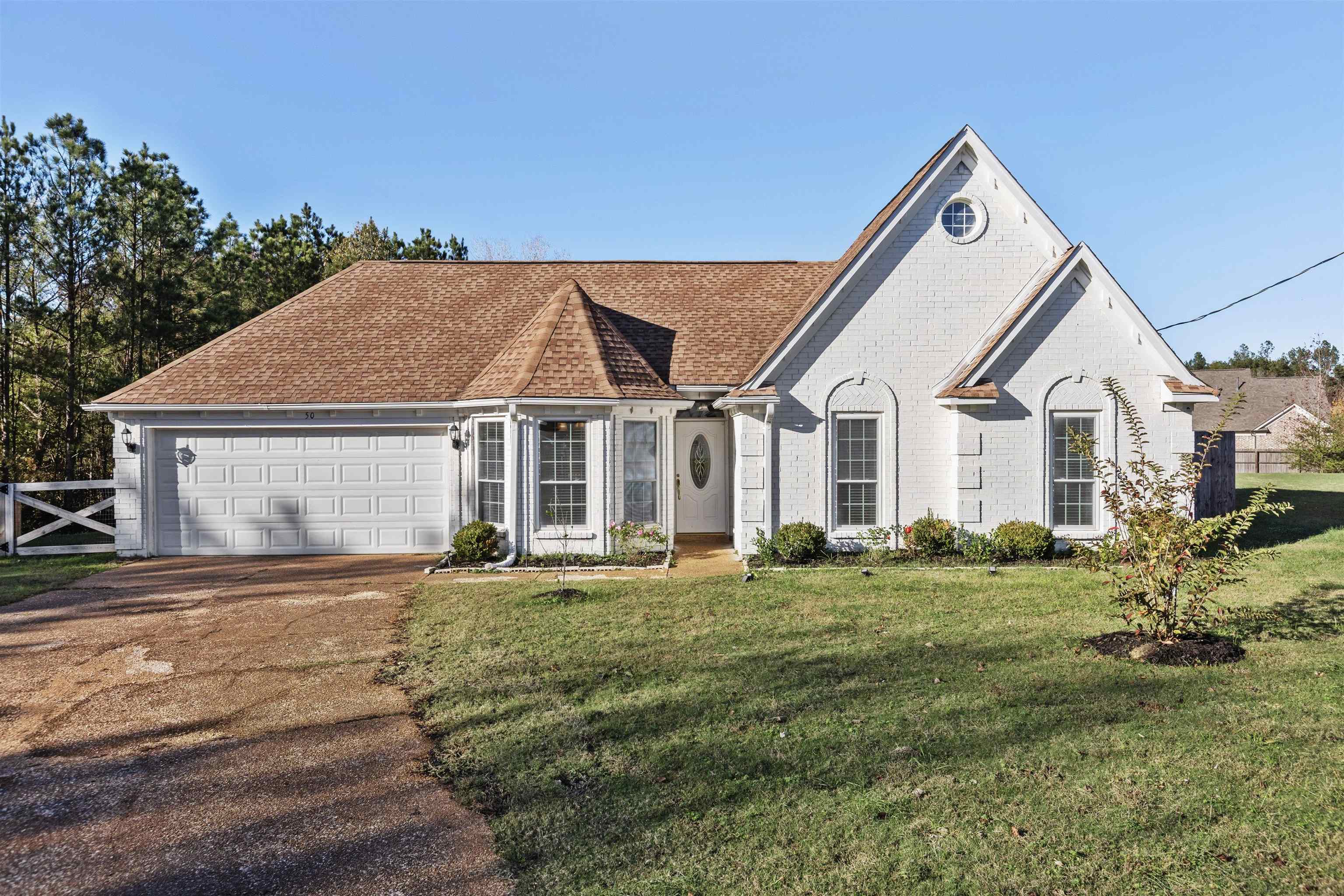 View of front of home with a front yard and a garage