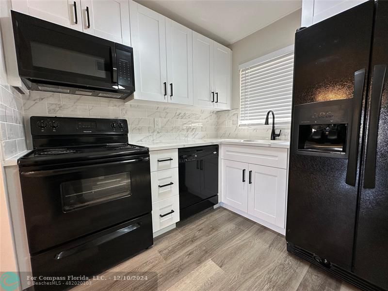 a kitchen with a stove and a microwave