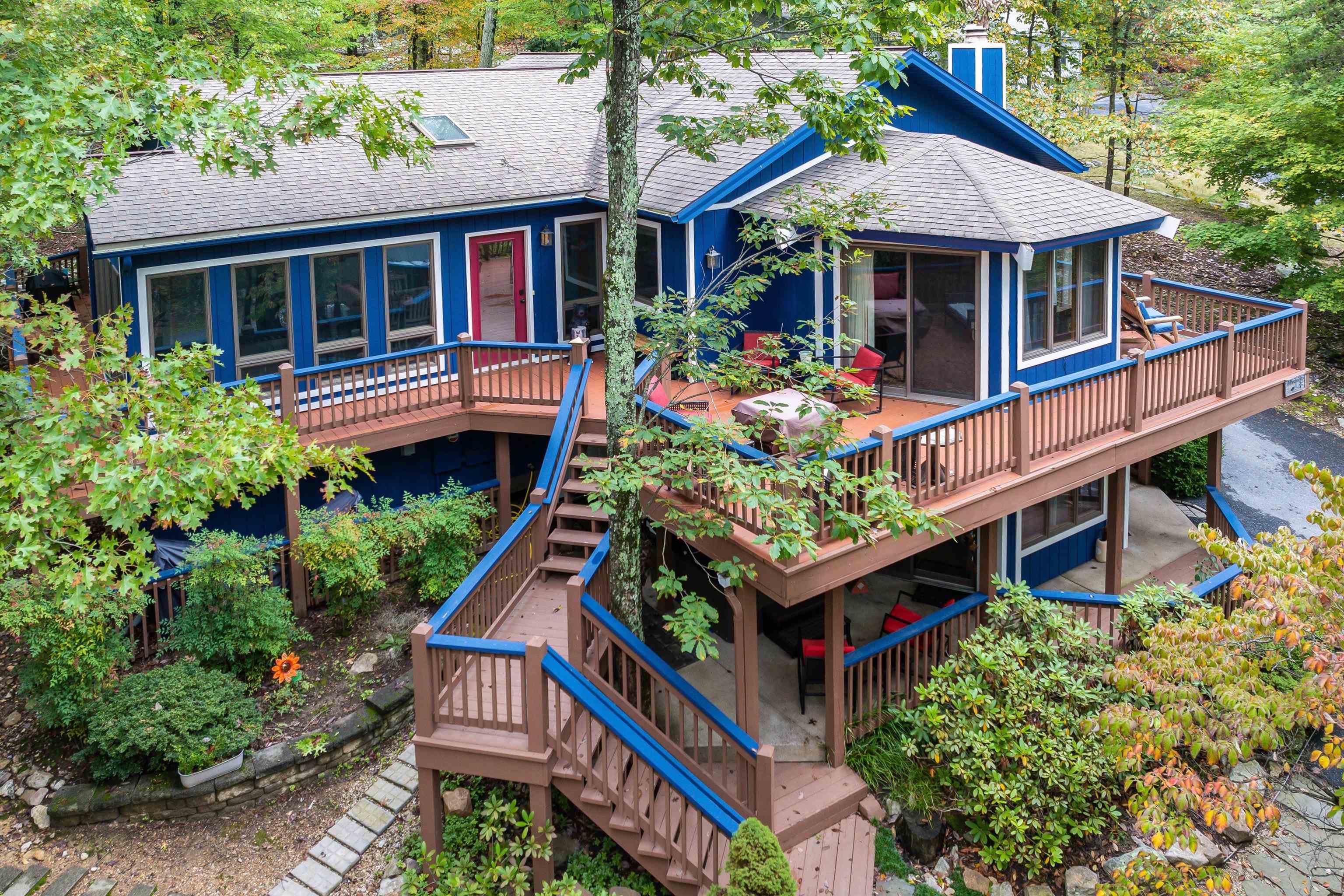 an aerial view of a house with balcony and trees