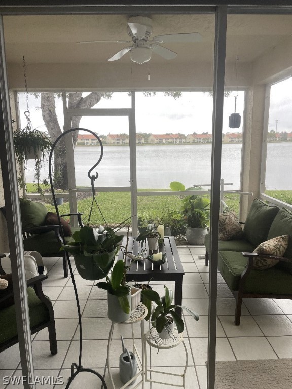 a living room with patio furniture and a floor to ceiling window