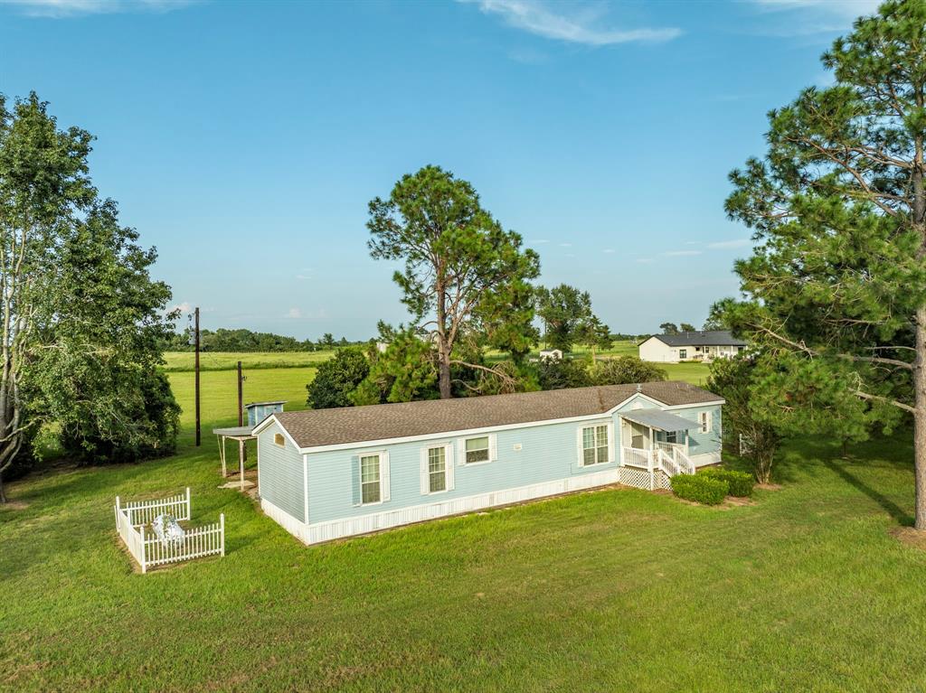 an aerial view of a house with swimming pool garden view and trees