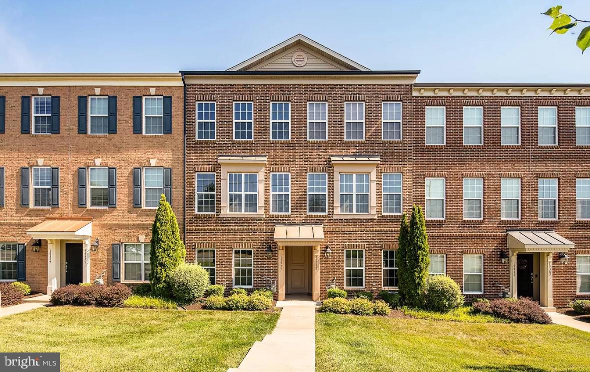 a front view of a residential apartment building with a yard