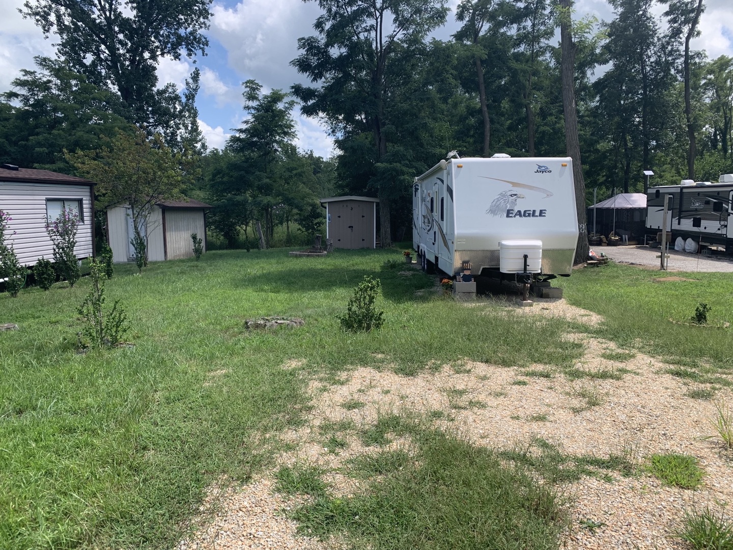 a view of a house with backyard and a garden