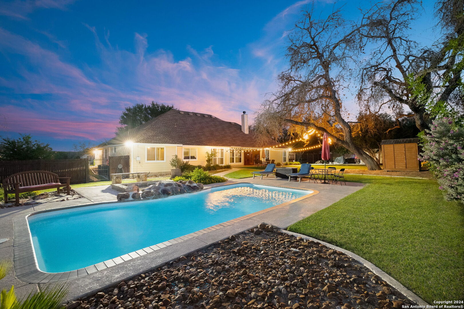 a view of a swimming pool with an outdoor seating and a garden