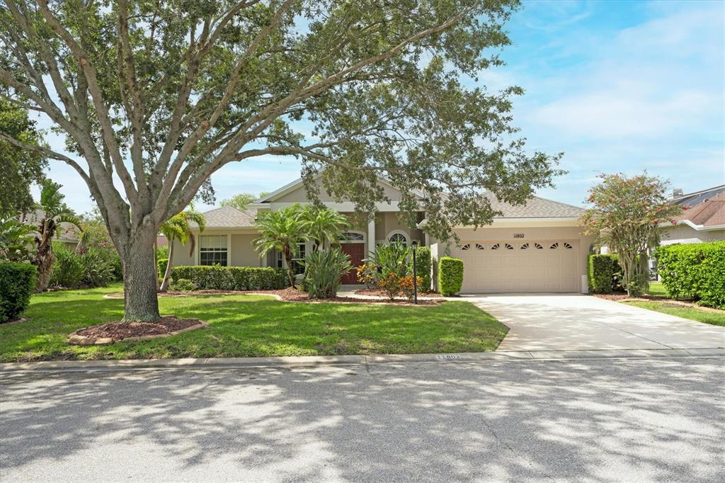 a front view of a house with a yard and trees