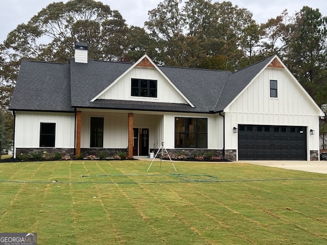 a front view of a house with yard and garage