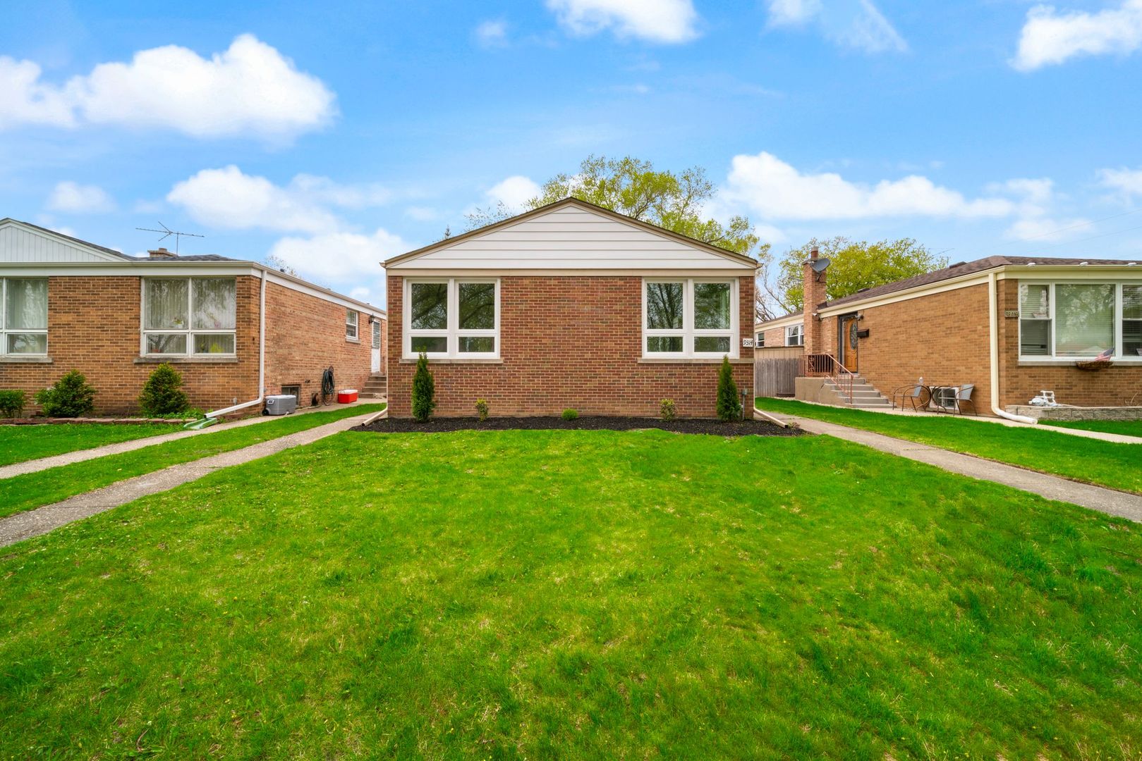 a front view of house with yard and green space