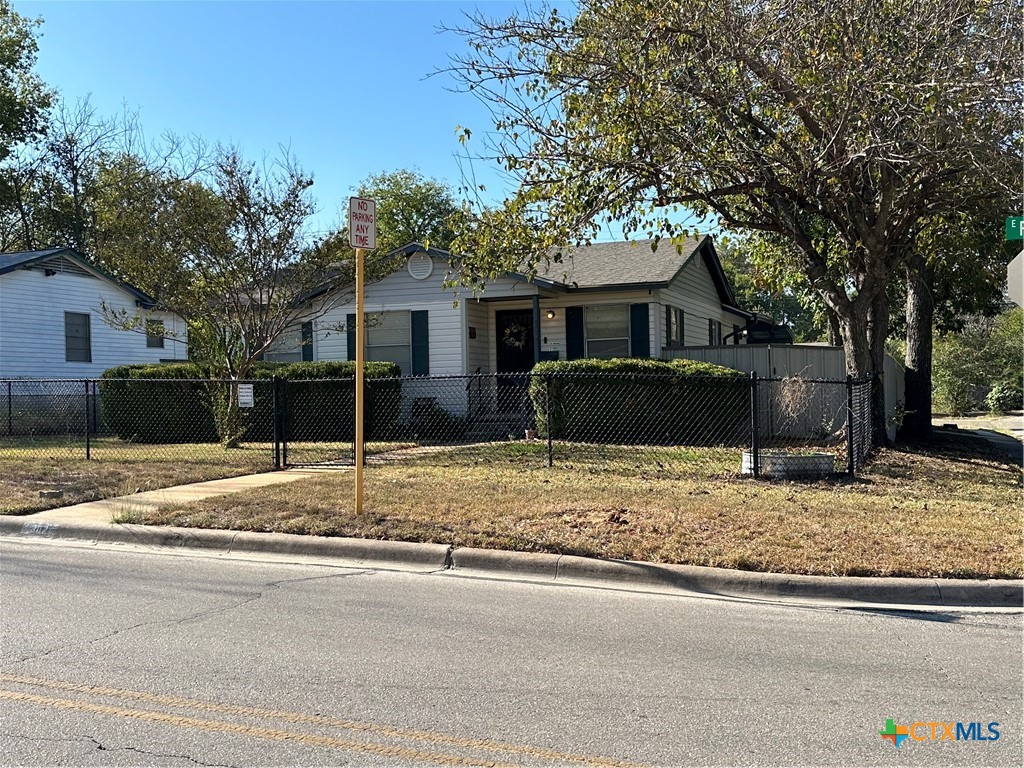 a house that has a tree in front of it