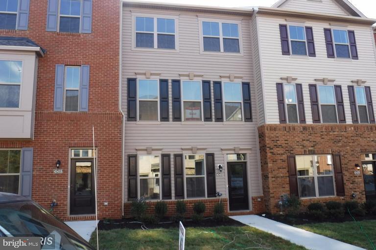 a large brick building next to a yard