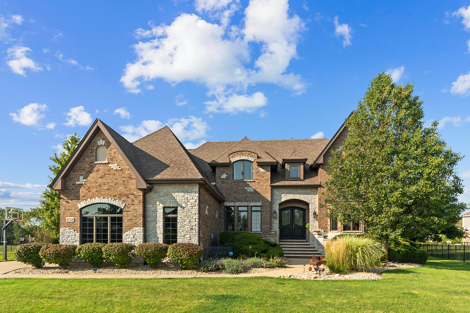 a front view of a house with a garden