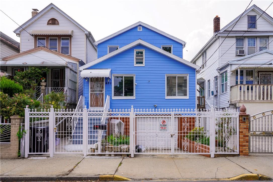 View of front of property featuring cooling unit and a garage