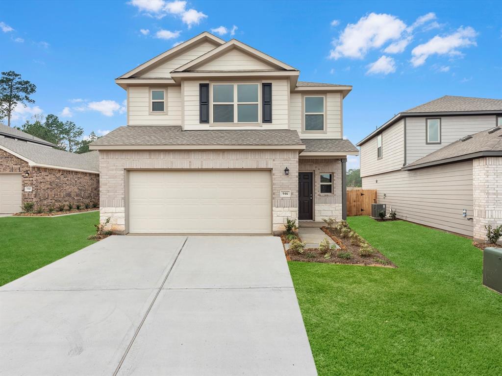 a front view of a house with a yard and garage