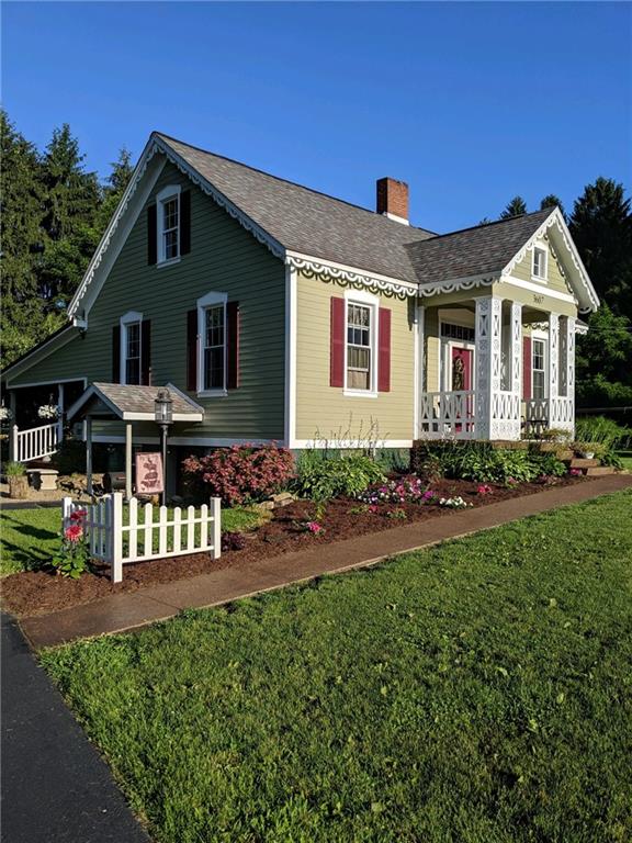 a front view of house with yard outdoor seating and barbeque oven