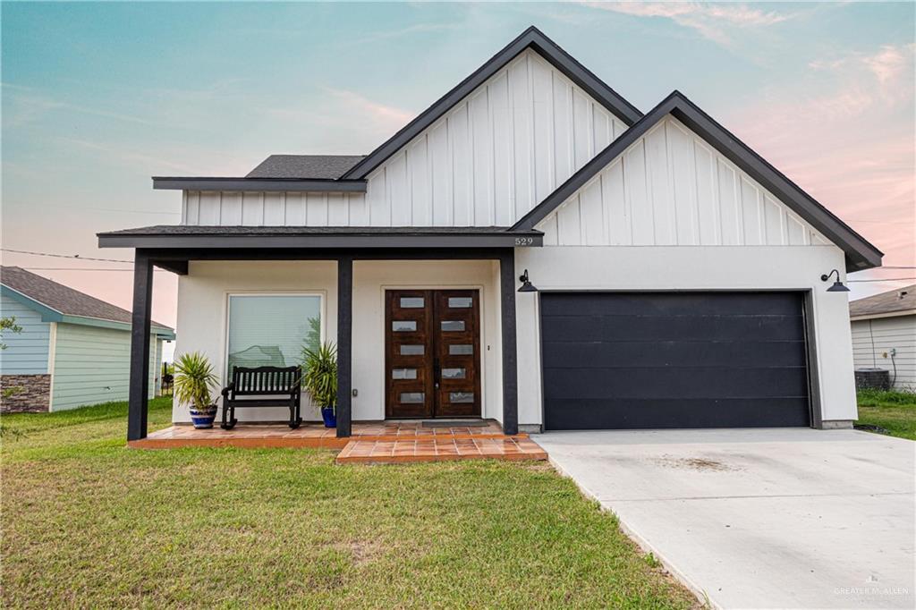 a front view of a house with a yard and garage