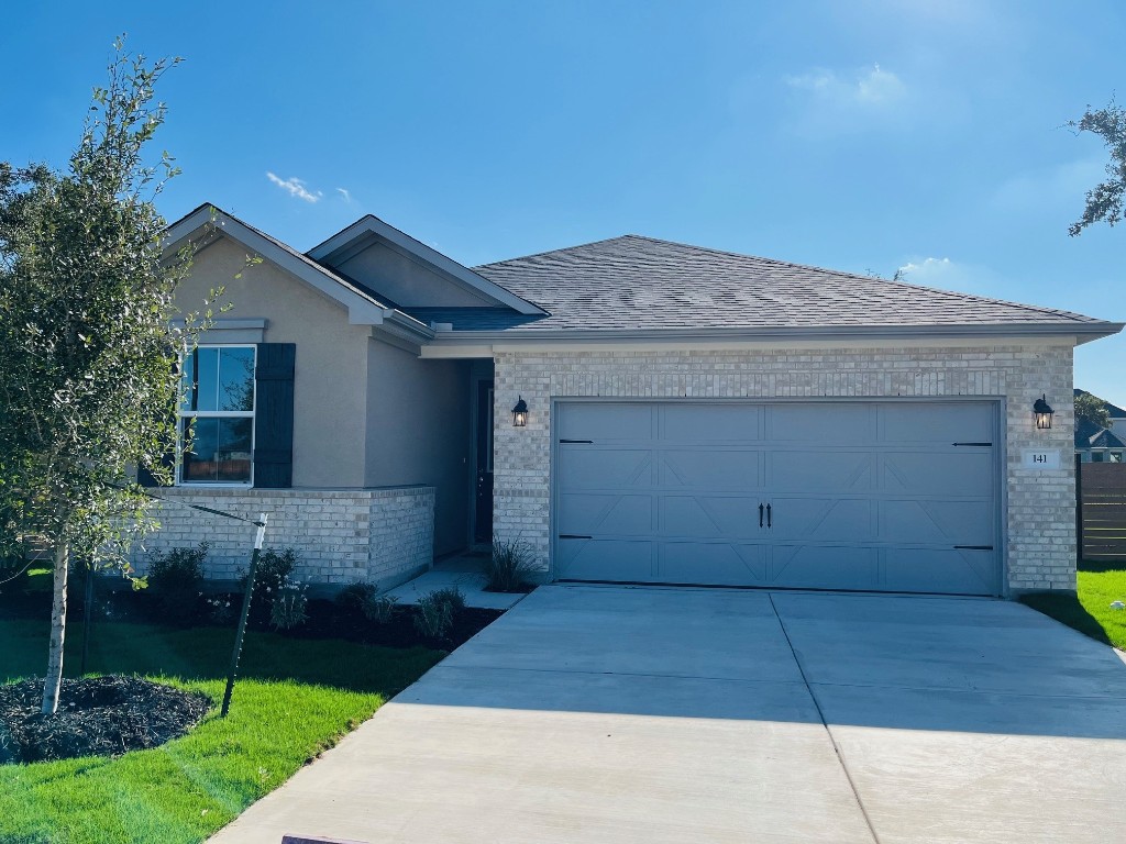 a front view of a house with a yard