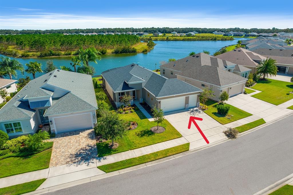 an aerial view of a house with outdoor space and lake view