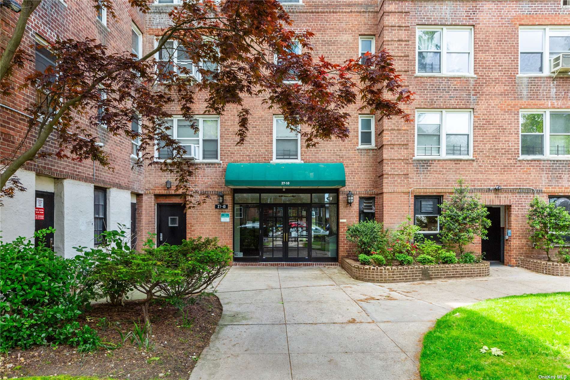 a front view of a building with garden