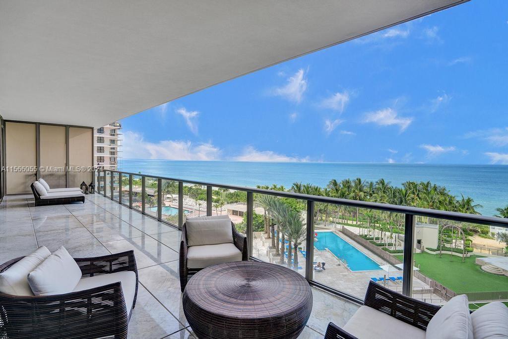 a balcony with furniture and city view