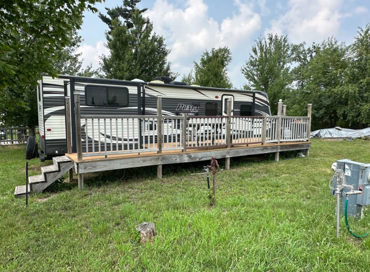 a view of a deck with a bench in a yard