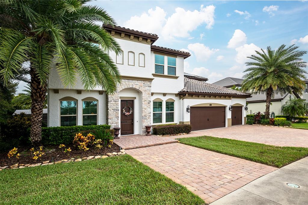 a front view of a house with a yard and garage