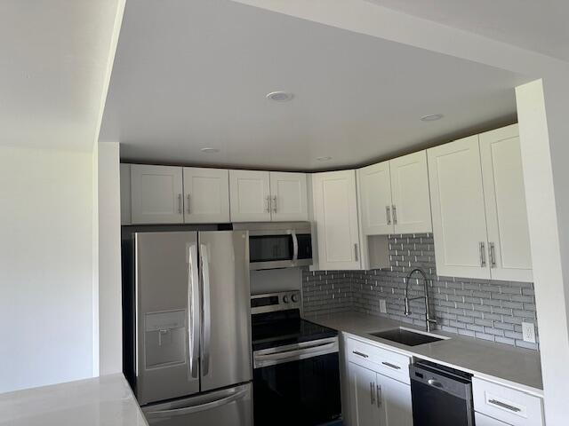 a kitchen with a refrigerator and a stove top oven