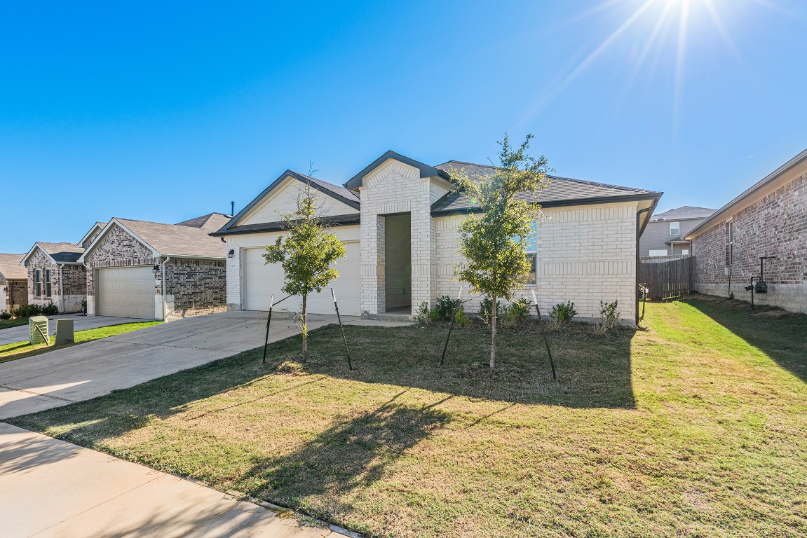 a front view of a house with a yard