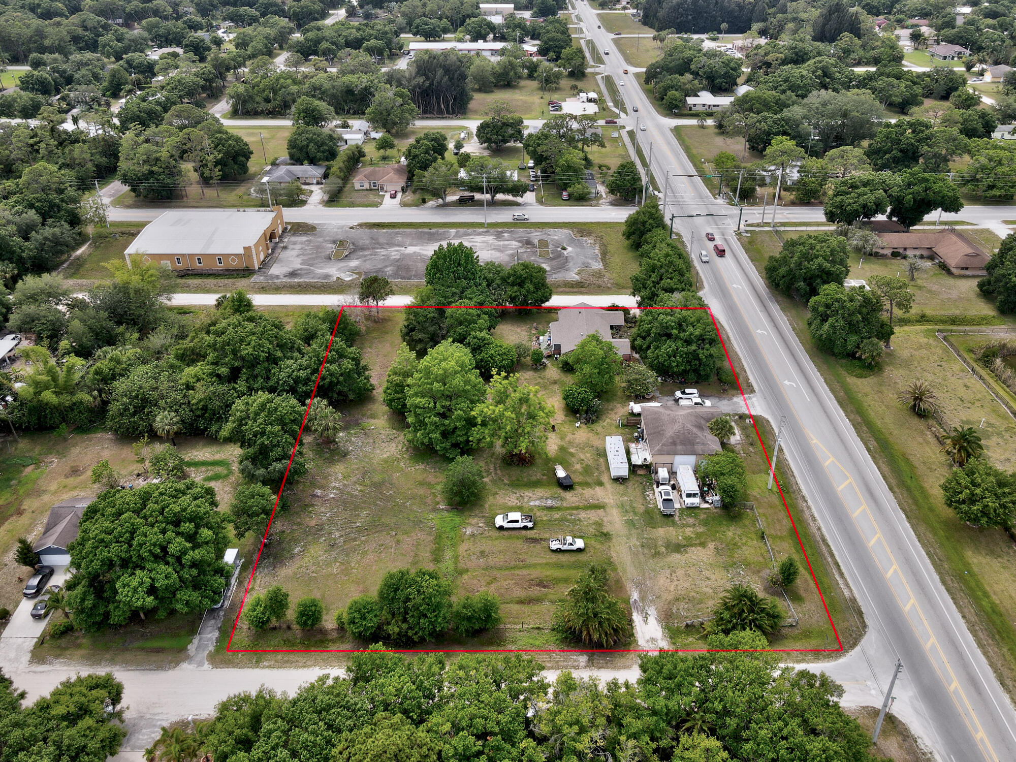 an aerial view of a residential houses with outdoor space and street view