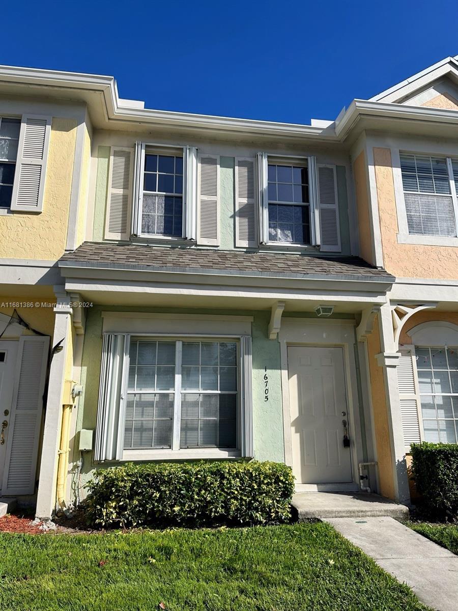 a front view of a house with a yard