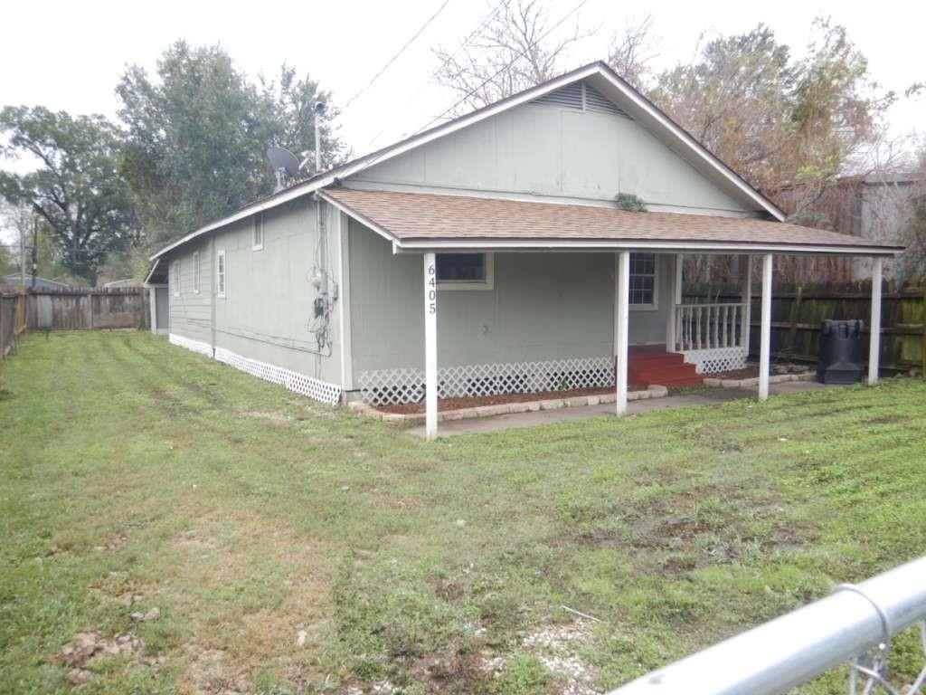 a view of a house with a backyard and porch