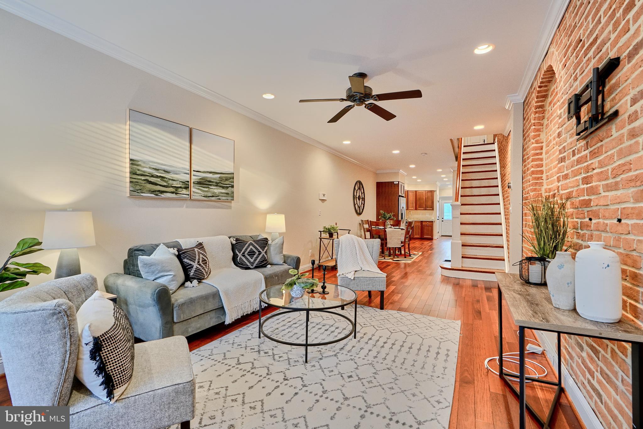 a living room with furniture and a wooden floor