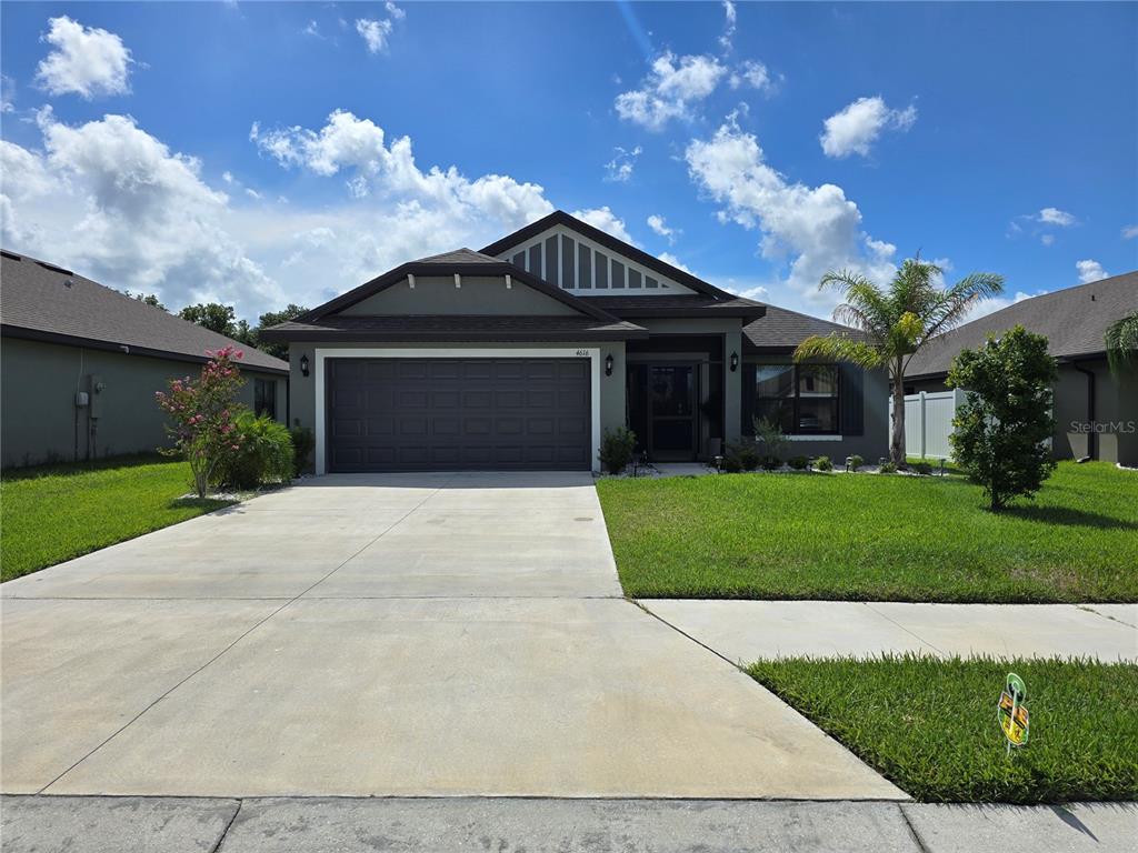 a front view of a house with a yard and garage