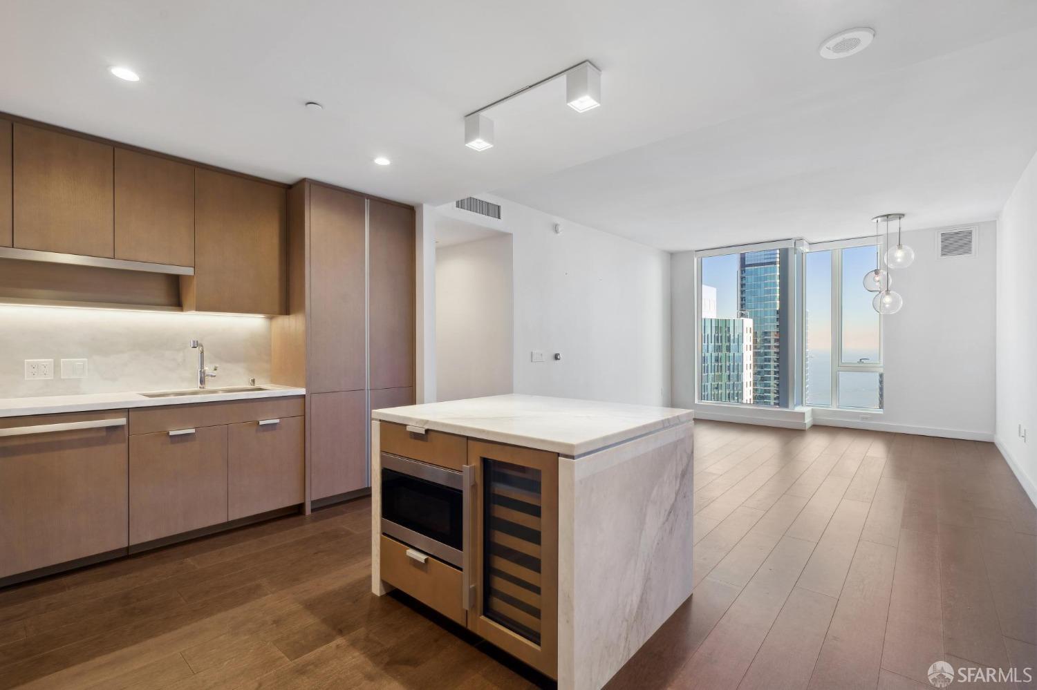 a kitchen with granite countertop a sink and a stove top oven