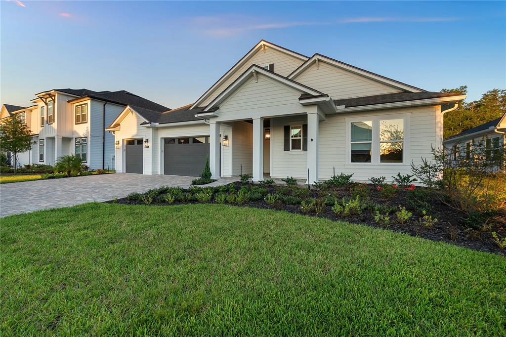 a front view of a house with a yard and porch