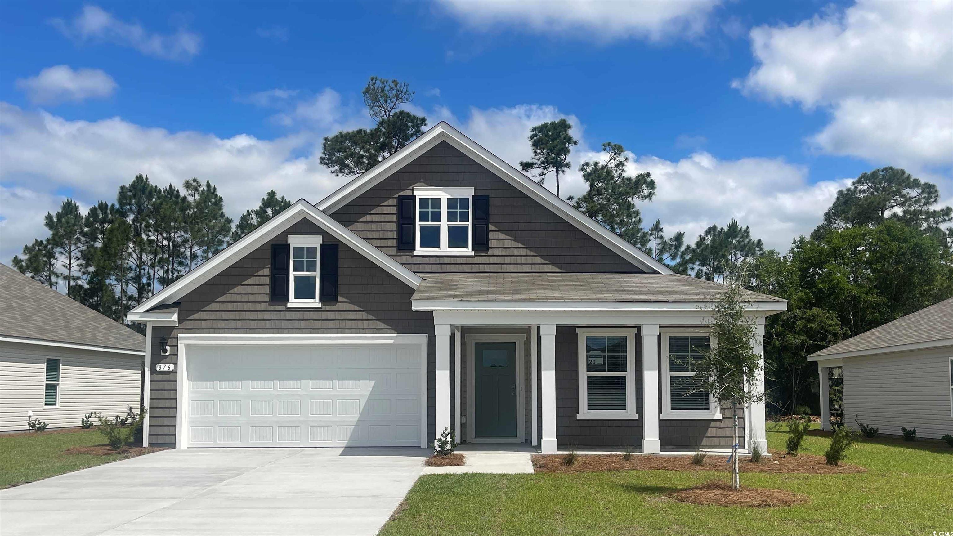 View of front of house with a front lawn and a gar