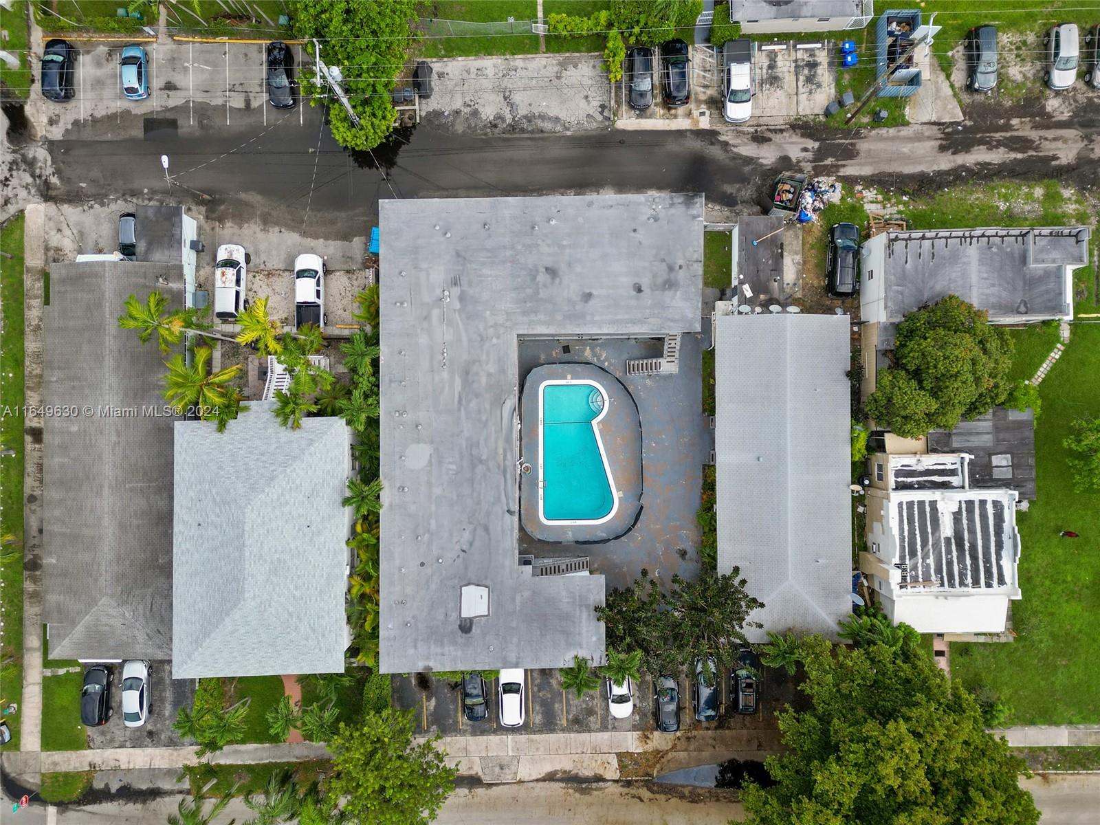 a aerial view of a house with a yard and potted plants