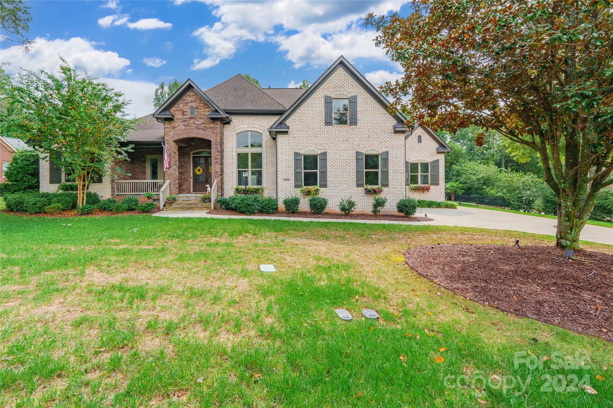 a front view of a house with a yard