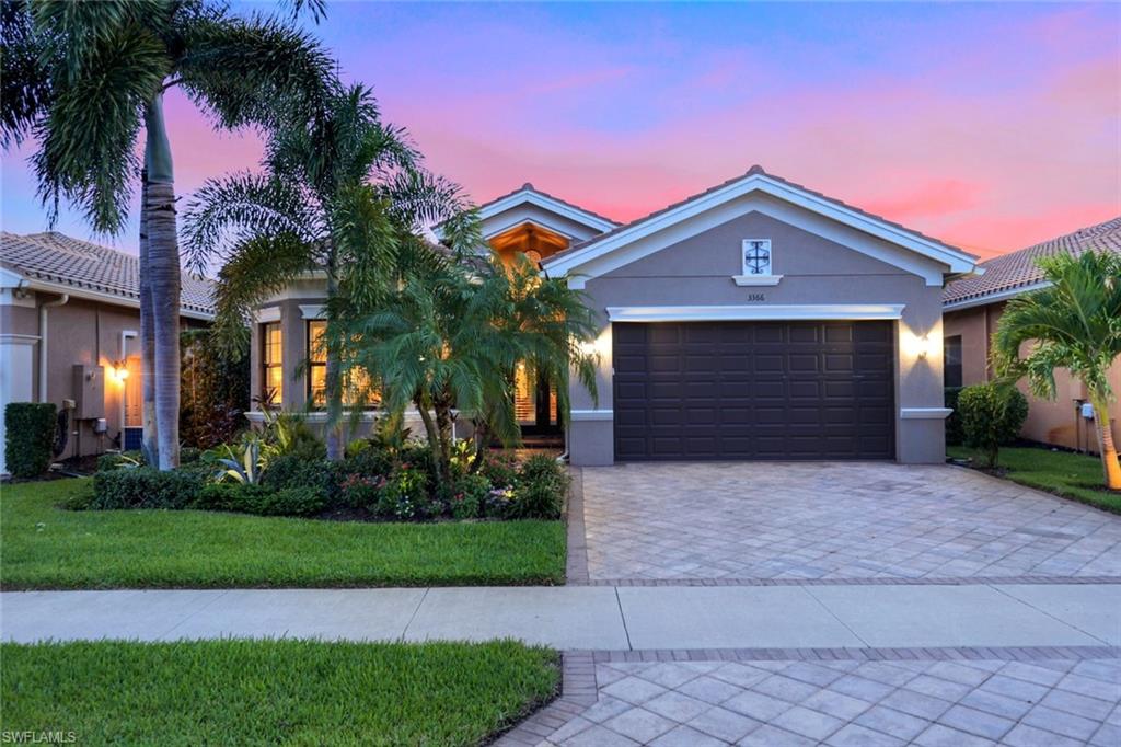 a front view of a house with a yard and a garage