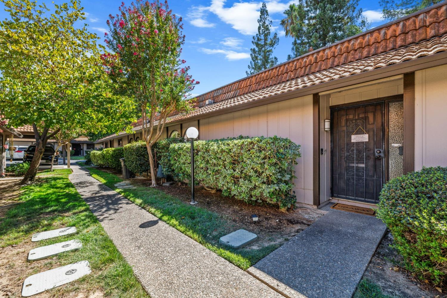 a front view of a house with garden